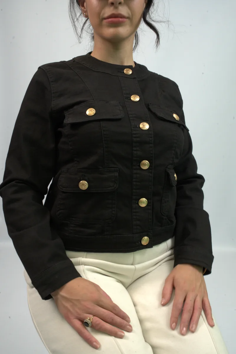 Kurt Muller womenswear campaign — black jacket with gold buttons